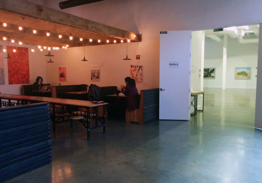 View of tables and the art gallery at Kickstarter